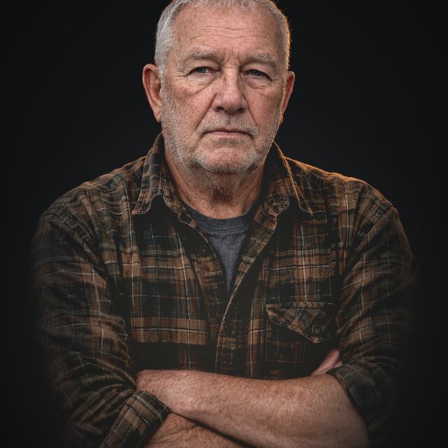 Wendell Coffey, arms crossed, in a flannel shirt